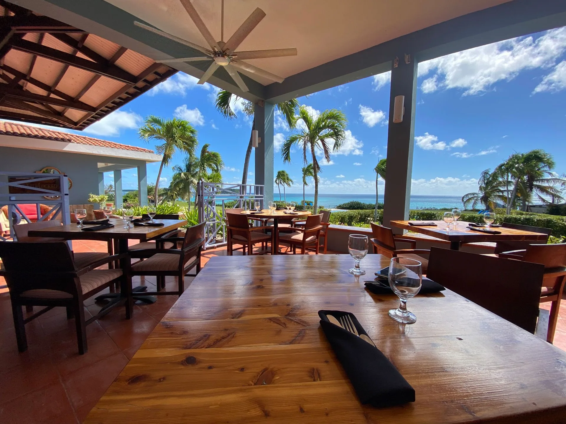 Oceanfront dining table with sea view at Carambola Restaurant