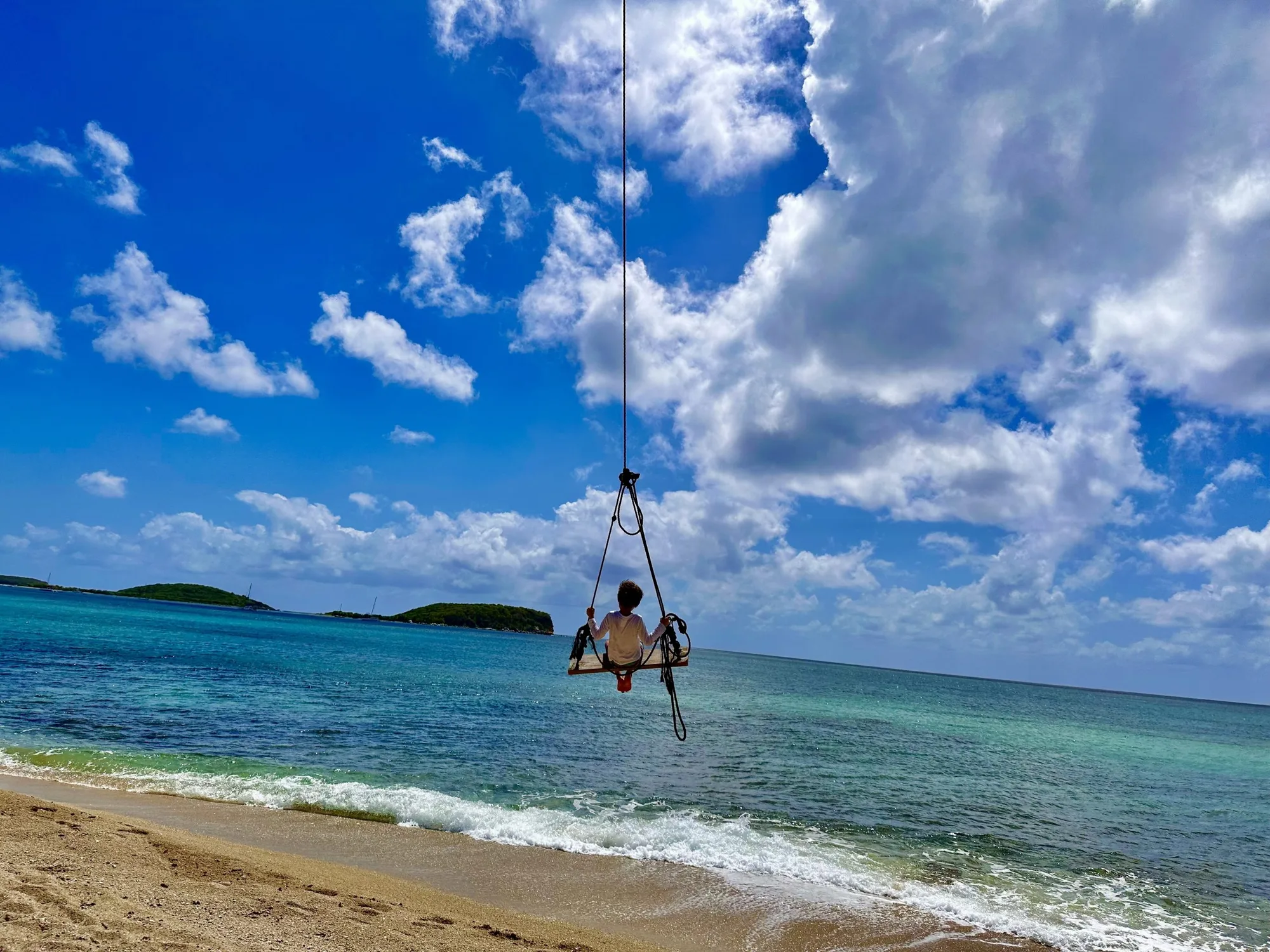 Beach swing over turquoise water at Coconut Beach, Vieques